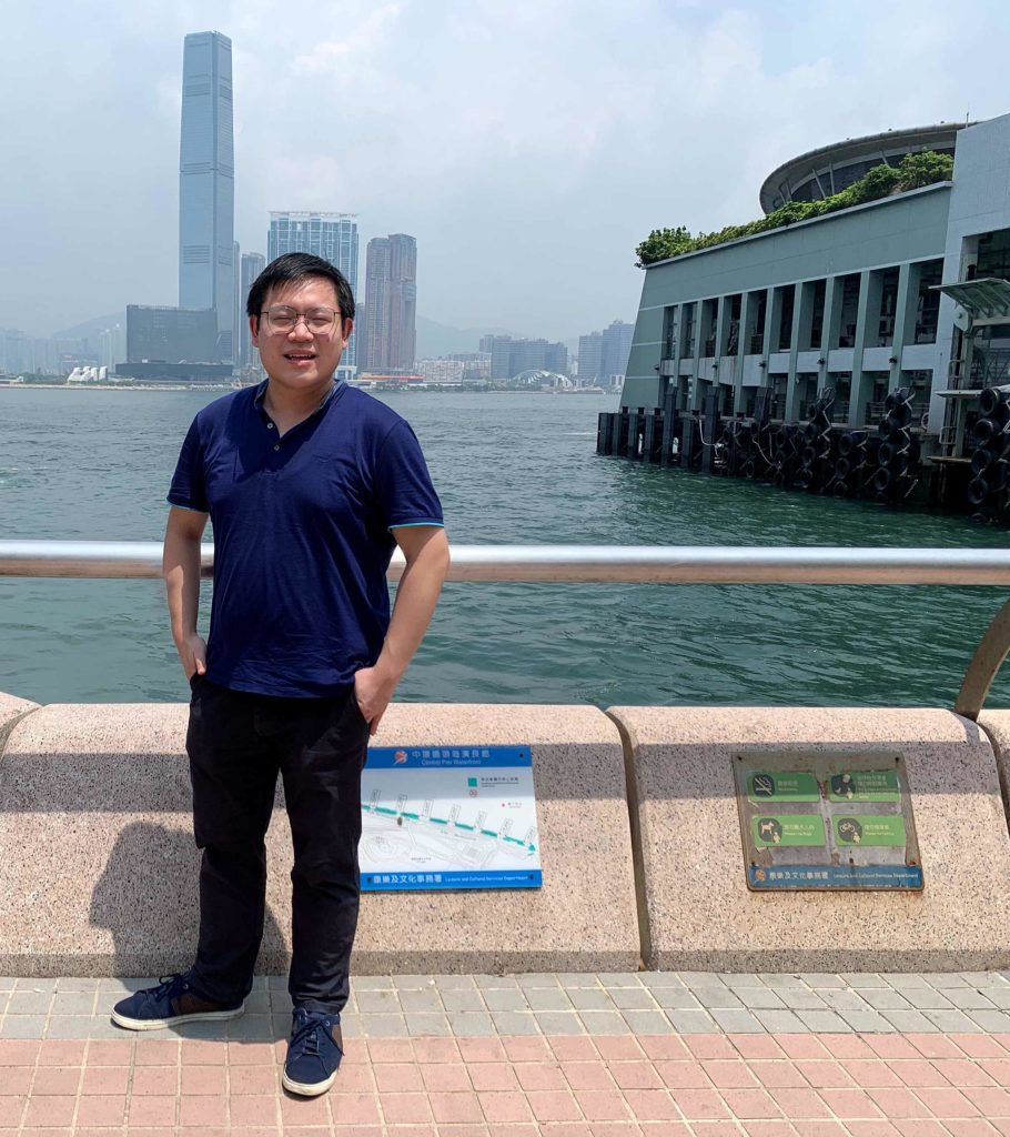 William Wong standing by Hong Kong harbour.